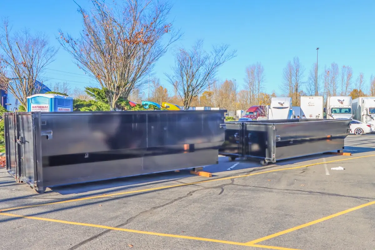 Professional dumpster rental service with roll-off container on residential driveway in Moraga